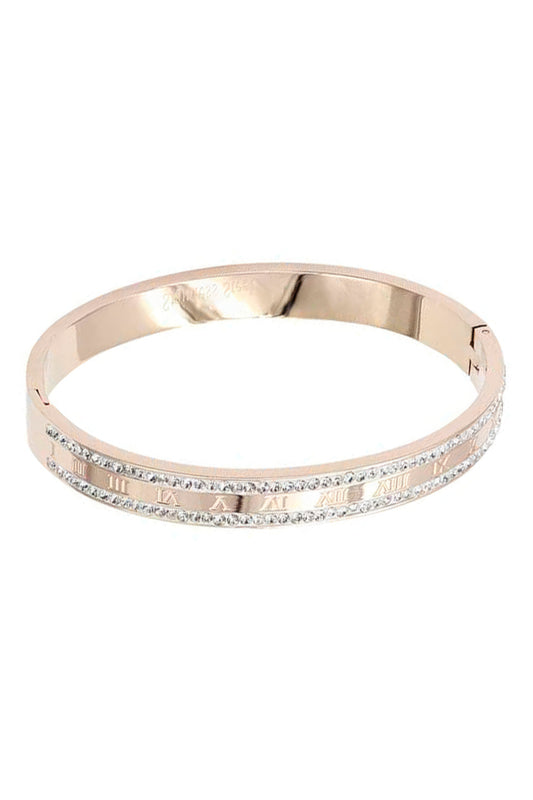 Brazalete de metal con borde de cristal y números romanos